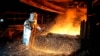 FILE - A worker in a protective suit pokes a metal rod to tap slag from a smelting furnace at PT Vale Indonesia's nickel processing plant in Sorowako, South Sulawesi, Indonesia, Sept. 12, 2023. 