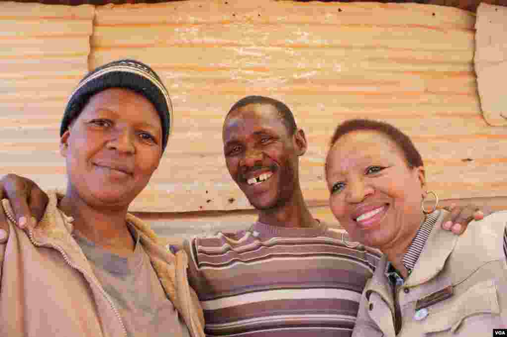 Mohalalelwa stands with his wife, Joyce (left) and Snowy Nkoana (right), a nurse he says saved his life. (Photo by Darren Taylor)