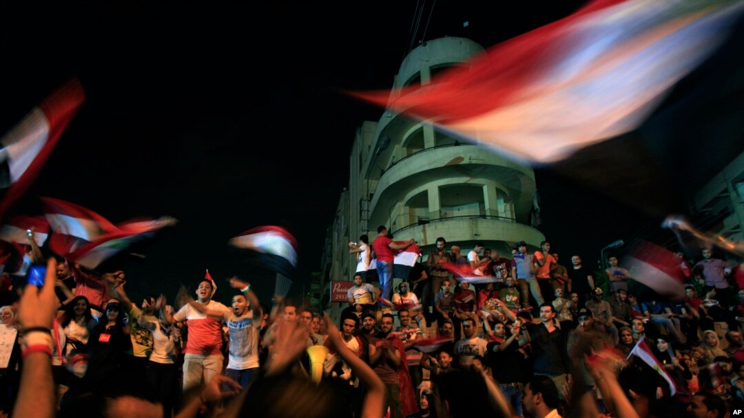 Opponents of Egypt's Islamist leader Mohamed Morsi celebrate outside the presidential palace in Cairo, July 3, 2013.