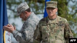 U.S. General Philip Breedlove (L) applauds as he stands next to U.S. General Curtis Scaparrotti during a ceremony on May 3, 2016, at the Patch Barracks in Stuttgart, southern Germany. During a ceremony, Breedlove handed over the U.S. European command to S