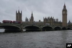 The British Houses of Parliament sit across the River Thames in London on May 3, 2024. London Mayor Sadiq Khan, who won reelection on May 4, says he will make the polluted river clean enough to swim in.
