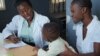 A medical worker attends to a child at Ndirande Health Center, one of eight health centers using the Chipatala Robot program in southern Malawi.