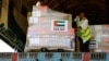 Workers unload aid from World Health Organization (WHO) and UAE-AID from United Arab Emirates at the Port Sudan International Airport, Port Sudan, Sudan, May 5, 2023. 