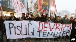 People hold a banner that reads "only revolution can clean this dirt " as they protest against corruption and the government of Prime Minister Recep Tayyip Erdogan in Ankara, Turkey, Dec. 28, 2013.