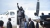 Second-in-command of South Sudan's rebels, Alfred Lado Gore, raises his fist after landing in the capital Juba, after more than two years in exile, April 12, 2016. Rebel leader Riek Machar is scheduled to return on April 18. 