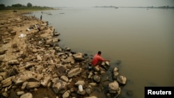 Personas pescan en las orillas del río Paraguay, que alcanzó bajos niveles récord de agua debido a una fuerte sequía. En Villeta, Paraguay, el 7 de septiembre de 2024.