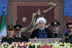 President Hassan Rouhani speaks at a military parade marking 39th anniversary of outset of Iran-Iraq war, in front of the shrine of the late revolutionary founder Ayatollah Khomeini, just outside Tehran, Sept. 22, 2019.