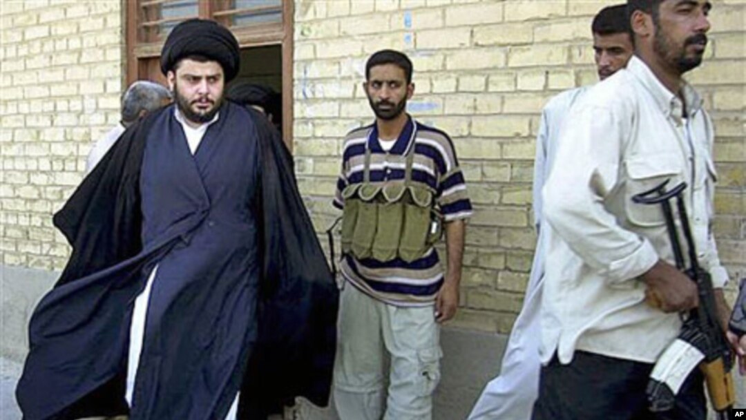 Shiite cleric Muqtada al-Sadr (L) - whose political party called December 26, 2011, for dissolution of Iraq's parliament and new elections in another move that could escalate country's growing sectarian crisis - steps from an office building in Najaf, Ira