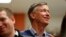 FILE - Former Colorado Gov. John Hickenlooper waits to speak at the Story County Democrats' annual soup supper fundraiser, Feb. 23, 2019, in Ames, Iowa. 