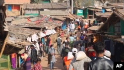 FILE - In this image from a video, Rohingya refugees walk at the Balukhali refugee camp in Cox's Bazar, Bangladesh, Feb. 2, 2021. Tens of thousands of Rohingya are believed to be trapped in fighting in western Myanmar as the Arakan Army battles the junta.