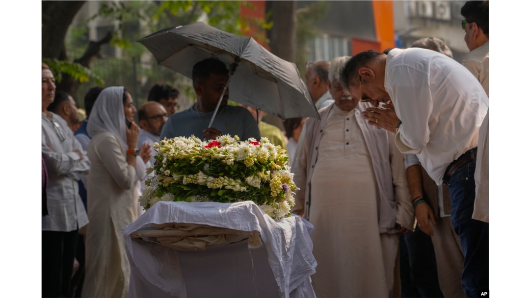 Bollywood actor Boman Irani, right, pays homage to Shyam Benegal, a renowned Indian filmmaker who passed away on Monday, during Benegal's funeral in Mumbai, Dec. 24, 2024.