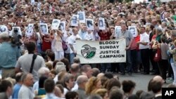 Relatives and families march to the Guildhall for a preview of the Saville report into the 1972 Bloody Sunday Shootings, in Londonderry, Northern Ireland, Tuesday, June, 15, 2010