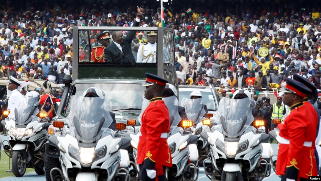 Kenya's out-going President Uhuru Kenyatta wavs to his supporters as he arrives for the swearing-in ceremony of the in-coming President William Ruto in Nairobi