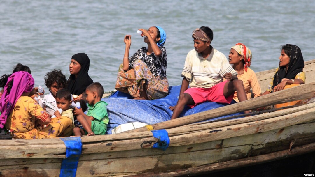 FILE - Muslim Rohingya people on a boat cross the river Naf, from Myanmar into Teknaf, Bangladesh, June 11, 2012. 