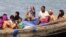 FILE - Muslim Rohingya people on a boat cross the river Naf, from Myanmar into Teknaf, Bangladesh, June 11, 2012. 