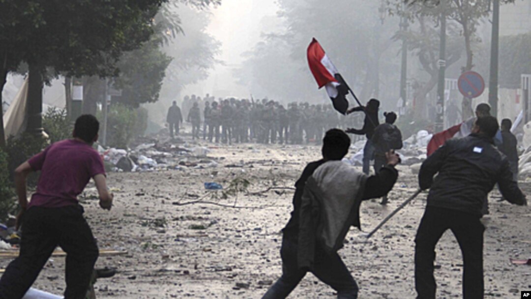 Egyptian protesters throw rocks and firebombs at military police during clashes near Cairo's downtown Tahrir Square, December 16, 2011.