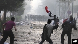 Egyptian protesters throw rocks and firebombs at military police during clashes near Cairo's downtown Tahrir Square, December 16, 2011.