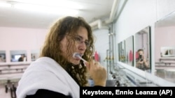 File: Liv Peters from Sennwald brushes her teeth in the washing room of the Zero Star Hotel in Sevelen, Switzerland, Saturday, Nov. 15, 2008