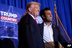 FILE - Republican presidential candidate former President Donald Trump appears on stage with former candidate Vivek Ramaswamy at a campaign event in Atkinson, N.H., January 16, 2024.