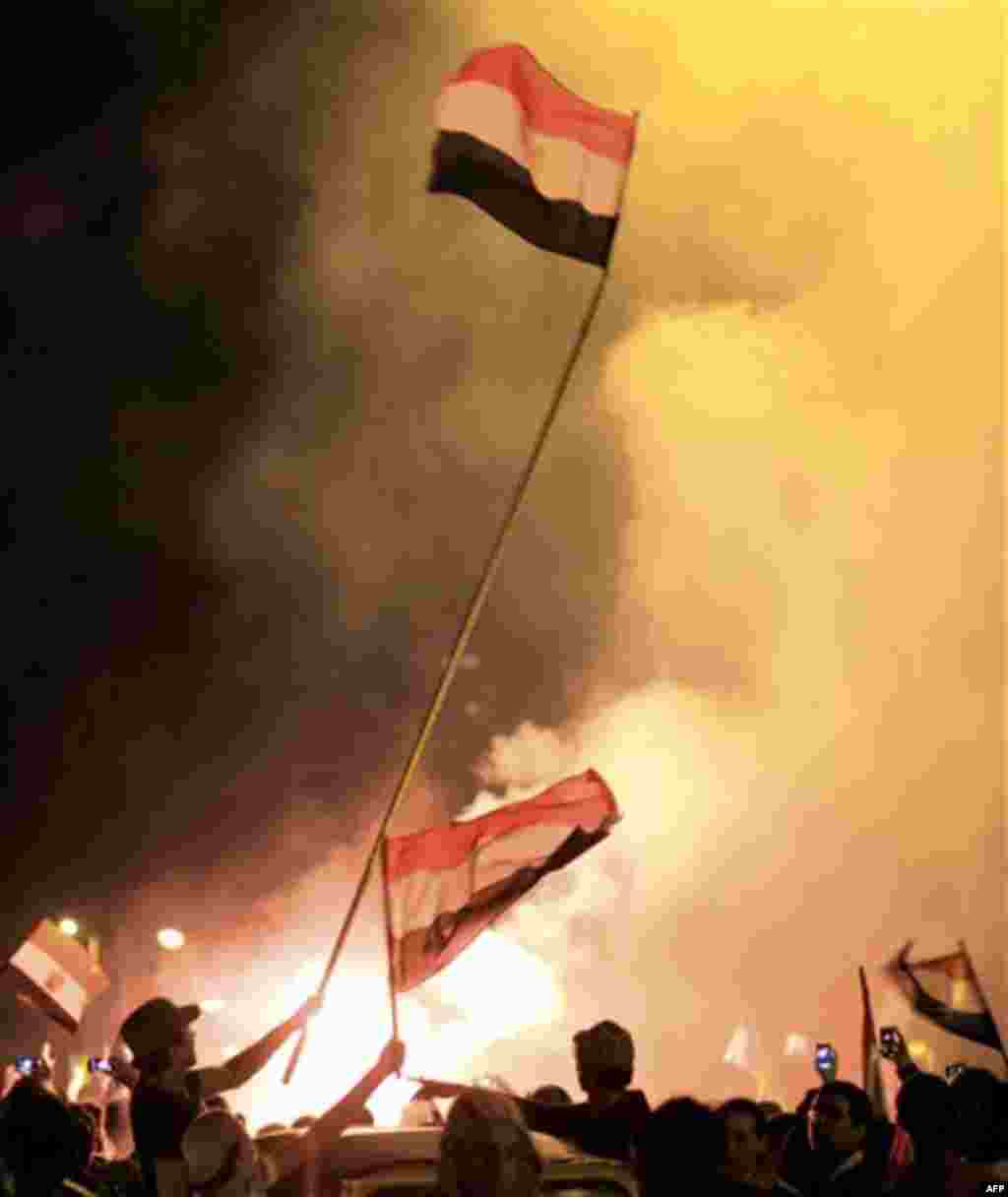 Egyptians celebrate after President Hosni Mubarak resigned and handed power to the military in Cairo, Egypt, Friday, Feb. 11, 2011. Egypt exploded with joy, tears, and relief after pro-democracy protesters brought down President Hosni Mubarak with a momen