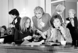 Women's rights activist Gloria Steinem, left, joins former congresswoman Bella Abzug, center, and actress Mary Tyler Moore, right, during a meeting of women's rights leaders on Capitol Hill in Washington, Feb. 4, 1981.