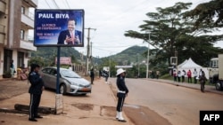 FILE - Police officers stand in front of the polling station where incumbent Cameroon President Paul Biya, is expected to vote, in Yaounde, Oct. 7, 2018. 