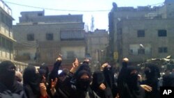 Demonstrators march through the streets after Friday prayers at Hajar Al Aswad in Damascus. Defying weeks of military crackdown, demonstrations broke out in Damascus suburbs, near the Lebanese border, July 1, 2011