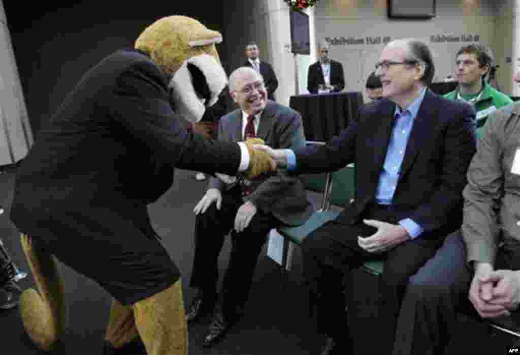 Microsoft co-founder Paul Allen, right, is greeted by Washington State University mascot Butch as campaign chairman Scott Carson looks on at a fund-raising kick-off for Washington State University Thursday, Dec. 2, 2010, in Seattle. WSU is getting a $26 m