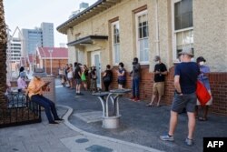 People wait in line to be tested for the coronavirus at Royal Perth Hospital, in Perth, Australia, Jan. 31, 2021.
