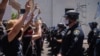 Demonstrators face-off with officers in front of the San Diego Police in downtown San Diego, California on May 31, 2020, as they protest the death of George Floyd.