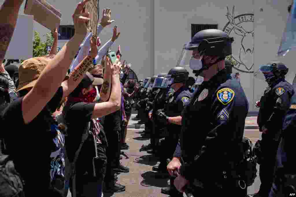 Demonstrators face-off with officers in front of the San Diego Police in downtown San Diego, California on May 31, 2020, as they protest the death of George Floyd.