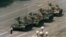 FILE - A Chinese man stands alone to block a line of tanks heading east on Beijing's Cangan Boulevard in Tiananmen Square, in early June 1989. 
