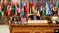 President Donald Trump takes a drink of water before delivering a speech to the Arab Islamic American Summit, at the King Abdulaziz Conference Center, May 21, 2017, in Riyadh, Saudi Arabia.