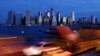 Early morning traffic in Brooklyn, New York moves slowly beneath the still-dark Manhattan skyline, November 1, 2012. New York is trying to resume its normal frenetic pace, but still finding it slow going on gridlocked highways.