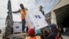 Boxes of AstraZeneca COVID-19 vaccine manufactured by the Serum Institute of India and provided through the global COVAX initiative arrive at the airport in Mogadishu, Somalia, March 15, 2021.