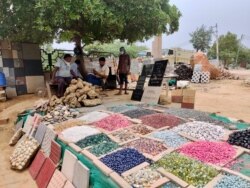 Roadside vendors selling colored tiles and stones have no business as traffic remains thin in cities. (Photo: Anjana Pasricha/VOA)
