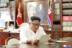 North Korean leader Kim Jong Un reads a letter from U.S. President Donald Trump, in Pyongyang, North Korea, in this picture released by North Korea's Korean Central News Agency, June 22, 2019.