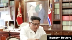  North Korean leader Kim Jong Un reads a letter from U.S. President Donald Trump, in Pyongyang, North Korea, in this picture released by North Korea's Korean Central News Agency, June 22, 2019.