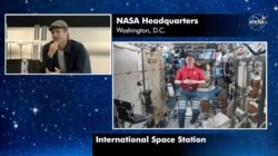 In this image taken from NASA video actor Brad Pitt, left, star of the new space movie “Ad Astra,” speaks from NASA headquarters in Washington, to astronaut Nick Hague abroad the International Space Station, Sept. 16, 2019.