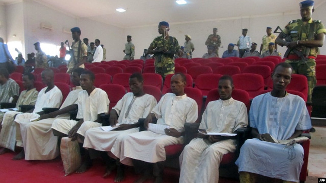 Suspected members of Boko Haram sit in court in N'Djamena, Nigeria, Aug. 26, 2015. 