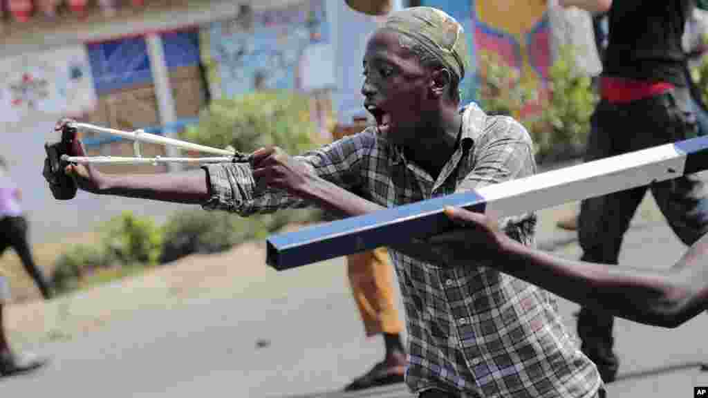 Um manifestante usa uma fisga durante confrontos com as forças de segurança no distrito de Cibitoke da capital Bujumbura, Burundi, 29 de Maio, 2015 &nbsp;