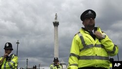 Police officers in London during a June protest against government austerity measures (file photo).