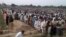 People offer funeral prayers for the victims of Sunday's fuel tanker fire in Bahawalpur, Pakistan, June 27, 2017. Thousands of mourners in Pakistan have attended the collective funeral for 130 victims of a massive fuel tanker fire on a central highway earlier this week. 
