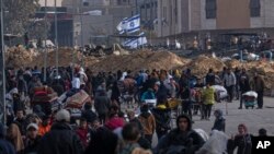 FILE - Palestinians flee Israeli ground offensive in Kahn Younis, Gaza Strip, Saturday, January 27, 2024.