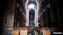 A view of the damaged roof and debris inside Notre-Dame de Paris in the aftermath of a fire that devastated the cathedral during the visit of French Interior Minister Christophe Castaner (not pictured) in Paris, France, April 16, 2019.