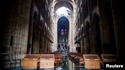 A view of the damaged roof and debris inside Notre-Dame de Paris in the aftermath of a fire that devastated the cathedral during the visit of French Interior Minister Christophe Castaner (not pictured) in Paris, France, April 16, 2019.