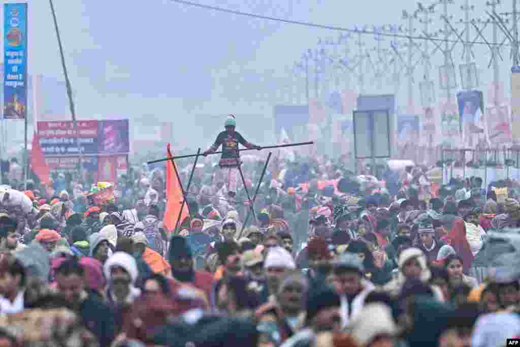 Hindu devotees gather along the banks of Sangam, the confluence of Ganges, Yamuna and mythical Saraswati rivers during the Maha Kumbh Mela festival in Prayagraj on Jan. 13, 2025.