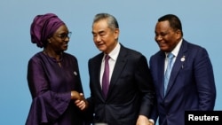 Senegal's Foreign Minister Yassine Fall, China's Foreign Minister Wang Yi and Republic of the Congo's Foreign Minister Jean-Claude Gakosso shake hands after a press conference in Beijing, Sept. 5, 2024. 