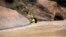 A member of a search and rescue team wades in to Virgin River during a search in Zion National Park, near Springdale, Utah, Sept. 16, 2015.