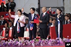 From left, Taiwan first lady Wu Mei-ru, President Lai Ching-te, Speaker of the Legislature Han Guo-yu and Vice President Hsiao Bi-khim wave during National Day celebrations in front of the Presidential Building in Taipei, Oct. 10, 2024.